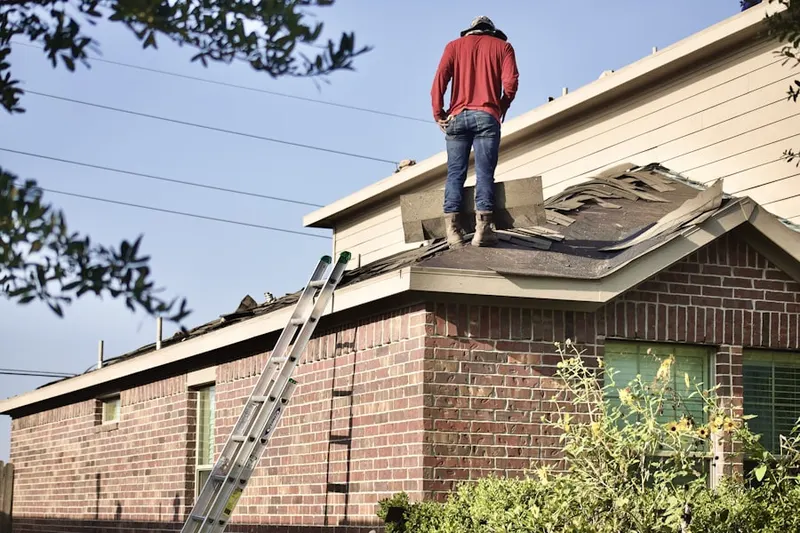 Professional roofer working on a residential roof in Boxboro